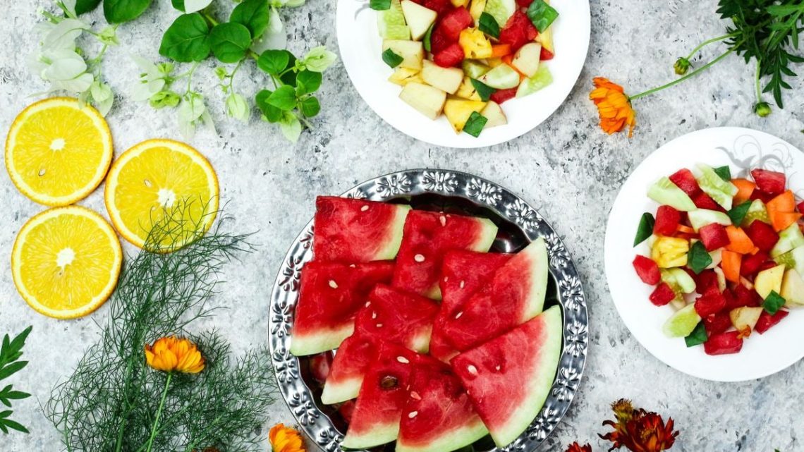 A colorful array of fresh fruit salad with watermelon and citrus, top view.