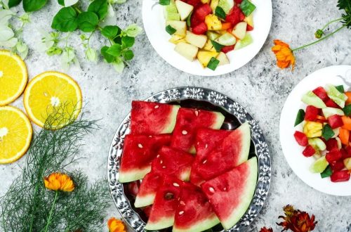A colorful array of fresh fruit salad with watermelon and citrus, top view.