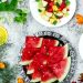 A colorful array of fresh fruit salad with watermelon and citrus, top view.